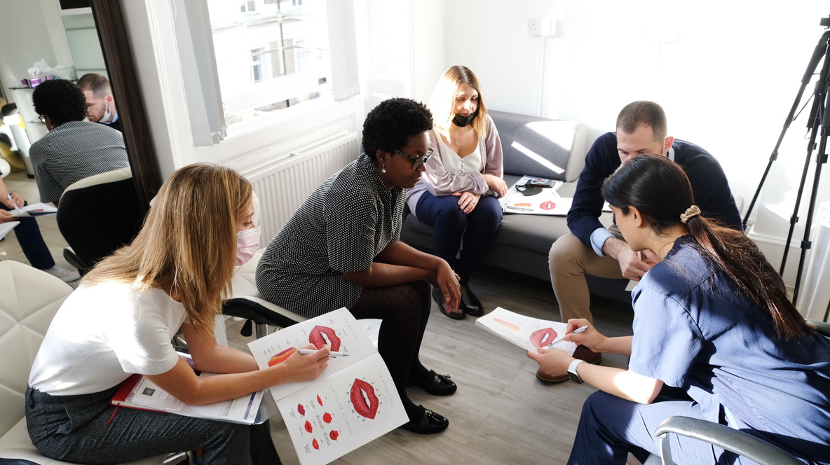 Practical Aesthetic Medicine Training | Harley Street Institute Hands-on aesthetic medicine training session at Harley Street Institute showing medical professionals learning dermal filler and botox injection techniques under expert supervision